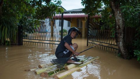 A man makes his way to his submerged house in Pengkalan Chepa, Malaysia, on Saturday. 