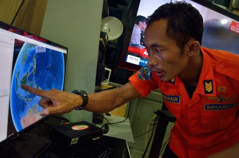 An official from Indonesia's national search and rescue agency points to the position where AirAsia Flight QZ8501 went missing.