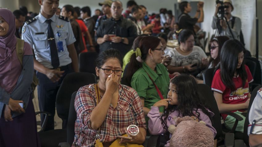 Family members of passengers of missing Malaysian air carrier AirAsia flight QZ8501 gather at Juanda international airport in Surabaya in East Java on December 28, 2014 hours after the news the flight went missing. The AirAsia Airbus plane with 162 people on board went missing en route from Indonesia to Singapore early on December 28, officials and the airline said, in the third major incident to affect a Malaysian carrier this year.   AFP PHOTO / Juni KRISWANTO        (Photo credit should read JUNI KRISWANTO/AFP/Getty Images)