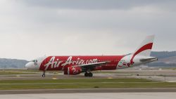 CORRECTS NUMBERS OF PASSENGERS ON BOARD - In this Nov. 26, 2014 photo, AirAsia Airbus A320-200 passenger jets are taxing on the tarmac at low cost terminal KLIA2 in Sepang, Malaysia. An AirAsia plane with 162 people on board lost contact with ground control on Sunday, Dec. 28, 2014, while flying over the Java Sea after taking off from a provincial city in Indonesia for Singapore, and search and rescue operations were underway. The plane in this photo is not the plane that went missing while flying from Indonesia to Singapore but one of the same models.  (AP Photo/Vincent Thian/AP)
