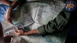 Indonesian Army personnel read a map during a search operation over the waters of the Java Sea on December 29.