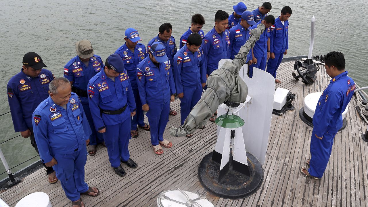 Members of Indonesia's Marine Police pray before a search operation on December 29.