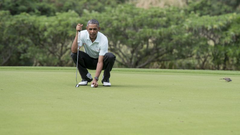 President Barack Obama prepares to putt as he plays golf with Malaysian Prime Minister Najib Razak at the Marine Corps Base in Hawaii in December 2014.