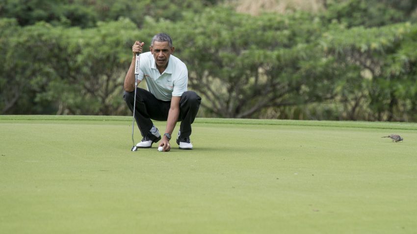 President Barack Obama prepares to putt as he plays golf with Malaysian Prime Minister Najib Razzak at the Marine Corps Base in Hawaii on Wednesday, December 24.
