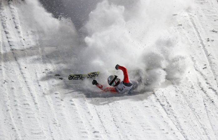 Swiss ski jumper Simon Ammann, an Olympic champion in 2002 and 2010, falls during the first round of the Four Hills Tournament on Monday, December 29.