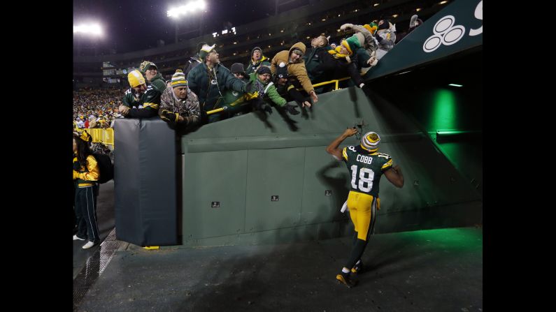 Green Bay Packers wide receiver Randall Cobb celebrates with fans after the Packers defeated Detroit 30-20 on Sunday, December 28. The home victory clinched the NFC North title and gave Green Bay a first-round bye in the playoffs.