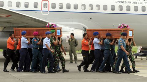 Indonesian soldiers carry coffins of crash victims on December 31.