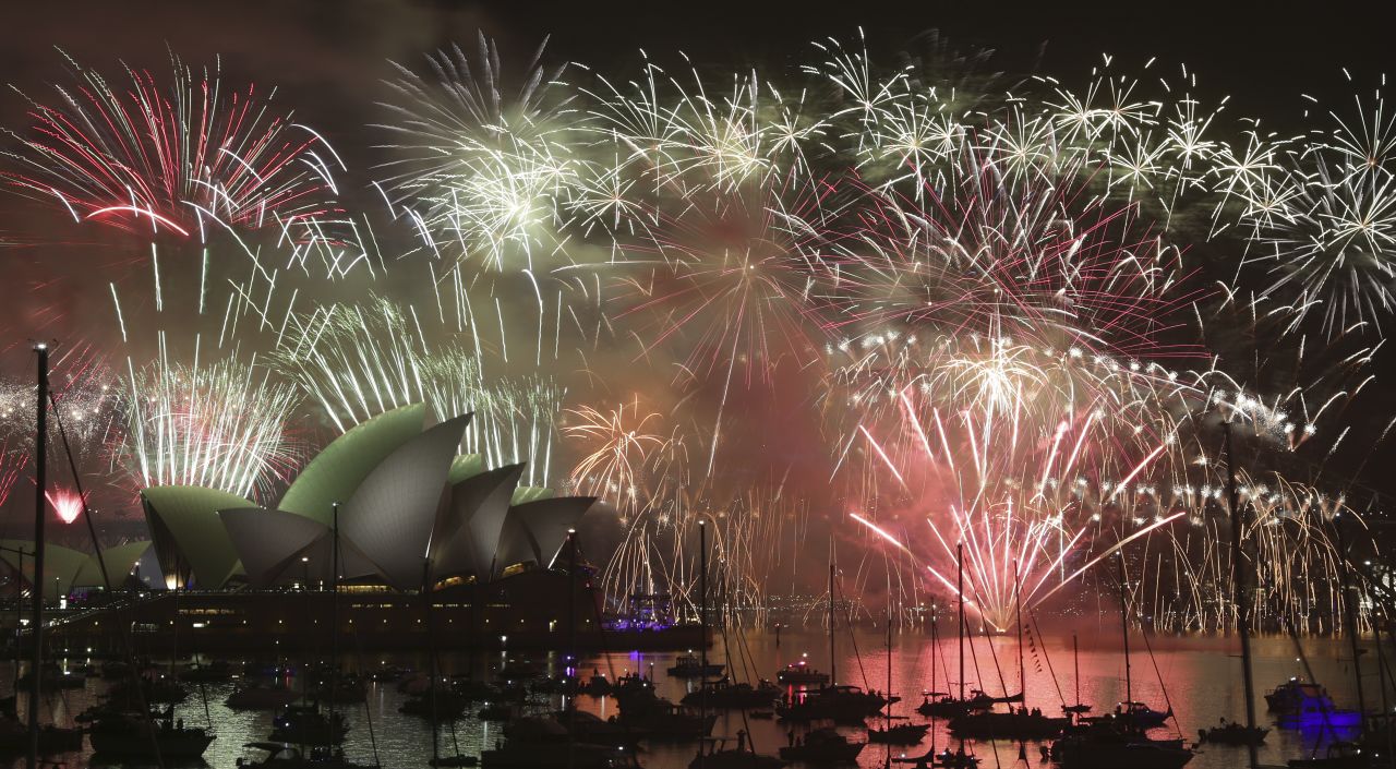 Fireworks light up the sky over the Sydney Opera House and the Sydney Harbour Bridge.