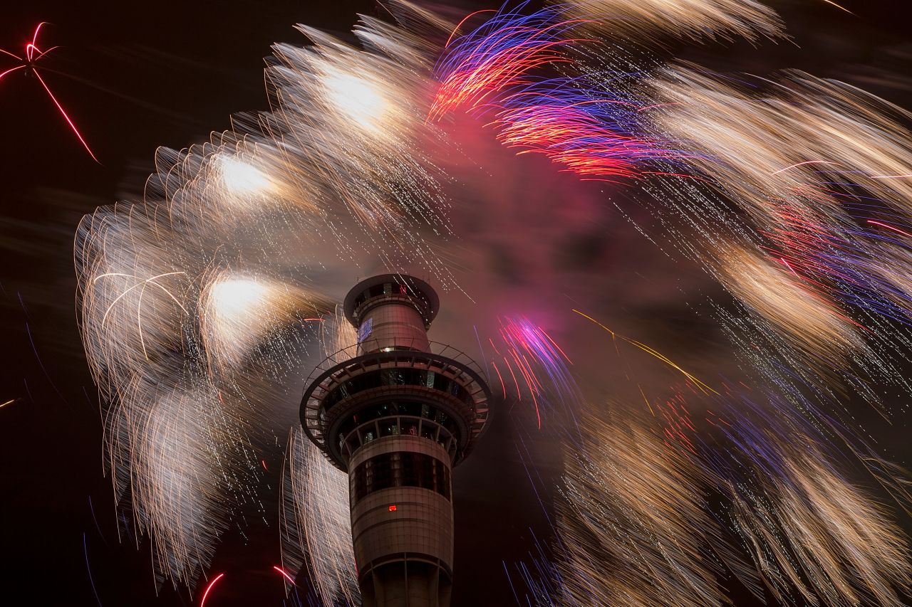 A fireworks display at the top of the Sky Tower welcomes the new year in Auckland, New Zealand. 