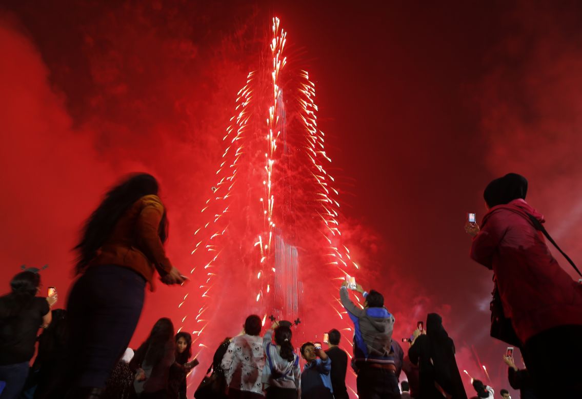 People in Dubai, United Arab Emirates, celebrate the new year with a light-and-sound extravaganza at the Burj Khalifa, the world's tallest skyscraper. The tower was lit up with colored panels as the clock counted down to 2015. 
