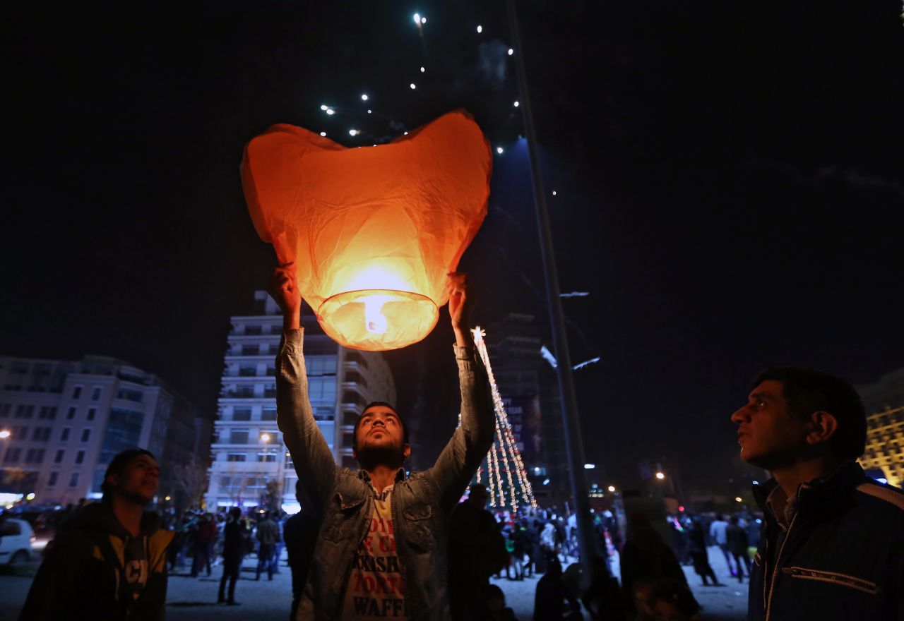 A  celebrant holds a heart-shaped balloon during the New Year's celebrations in downtown Beirut, Lebanon.