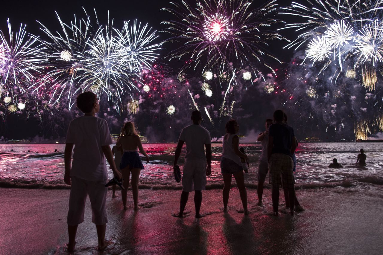 People watch fireworks from Copacabana beach.