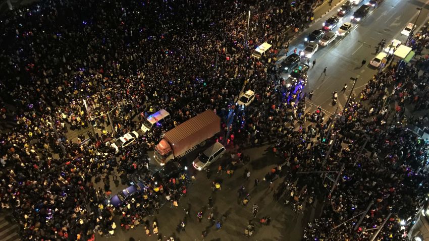 Caption:This overhead view shows emergency vehicles (C) amongst the crowd after a stampede by new year's revellers in Shanghai's historic riverfront in Shanghai on January 1, 2015. The stampede by New Year's revellers in Shanghai's historic riverfront area killed 35 people and injured dozens more, the city government said on January 1. CHINA OUT AFP PHOTO (Photo credit should read STR/AFP/Getty Images)