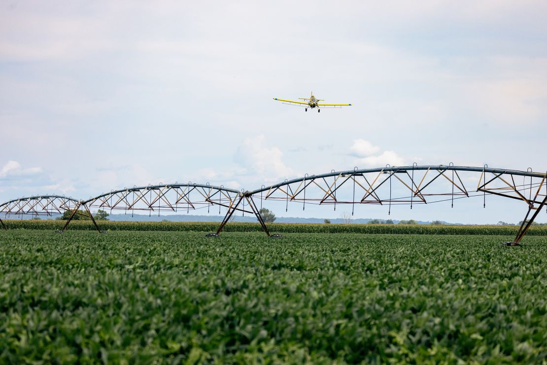 A crop duster applies nutrients on a field of soybeans in Modale, Iowa, as part of a Truterra initiative.