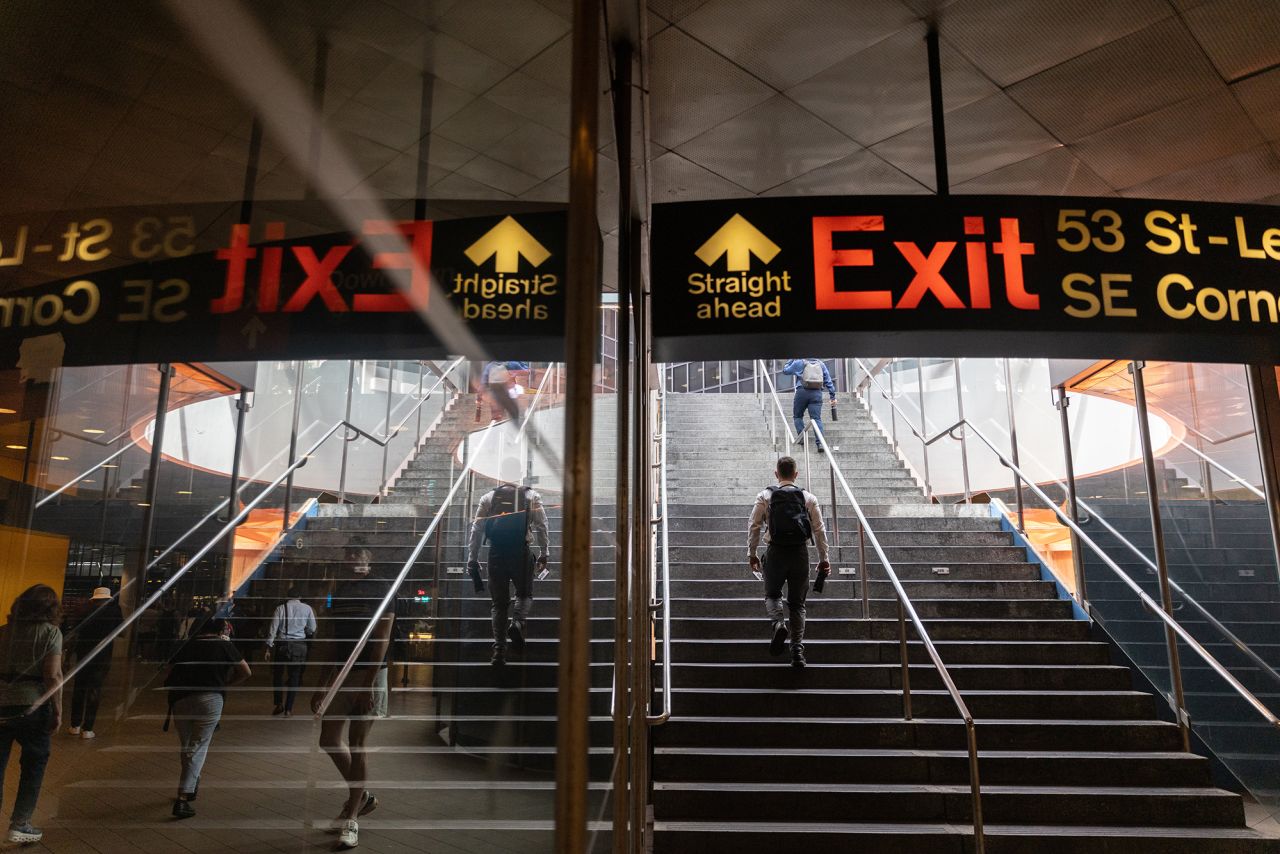 Commuters walk in a subway station in New York City on June 6.