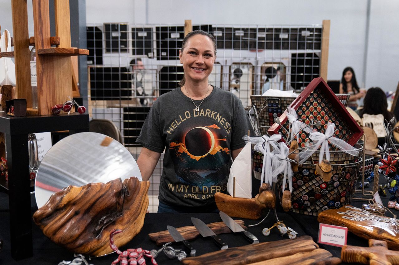 Dianna Carta sells handcrafted wood items at an eclipse-themed popup market in nearby Del Rio, Texas.