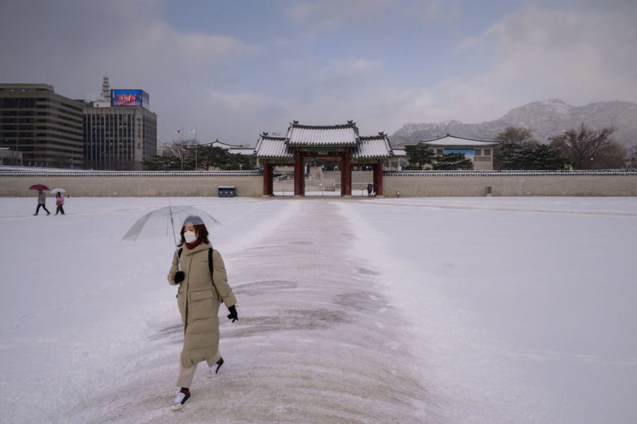 A visitor wearing a protective face mask walks through Gyeongbokgung Palace in Seoul, South Korea on February 17, 2020.