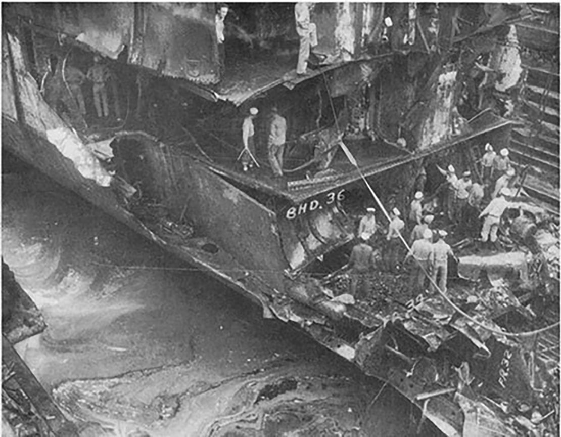 The cruiser USS New Orleans is seen in dry dock in Sydney, Australia, on February 3, 1943 as crew are clearing away wreckage left after a Japanese torpedo severed its bow.