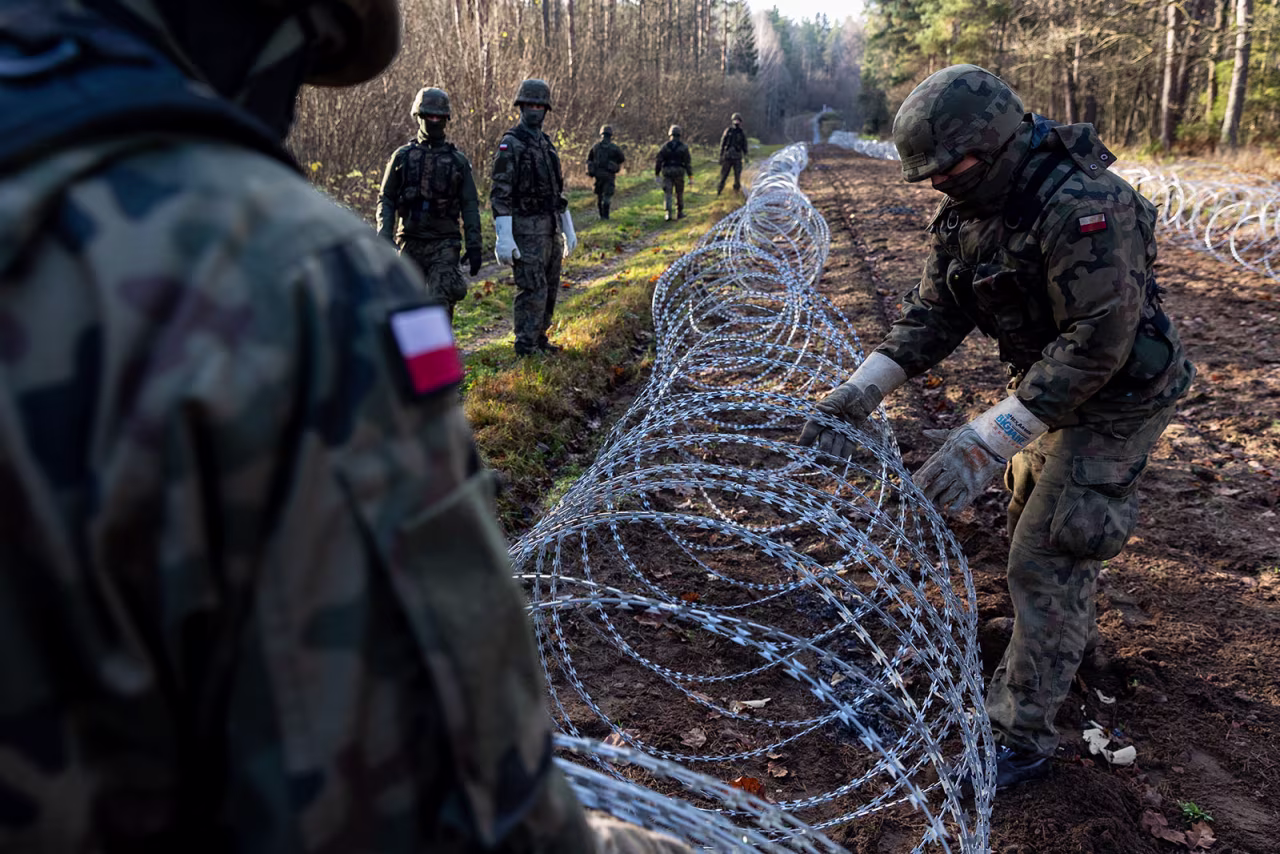 Soldiers of the Polish army install concertina wire at Poland's border with Russian exclave Kaliningrad on November 14, 2022 in Goldap, Poland.