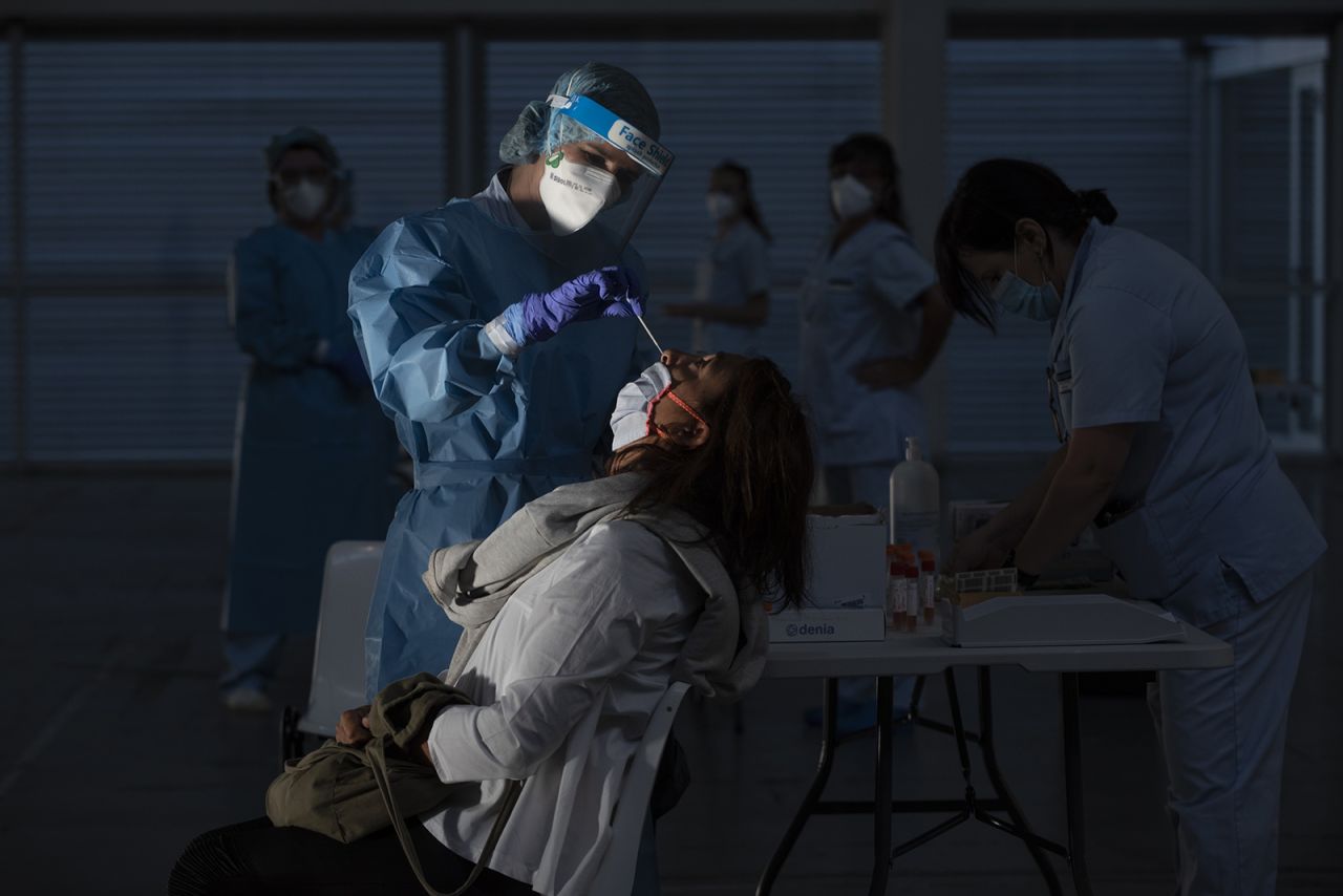 A health worker does a PCR test on a patient at Ficoba exhibition site, where mass coronavirus tests are being carried out on September 3, 2020 in Irun, Spain. 