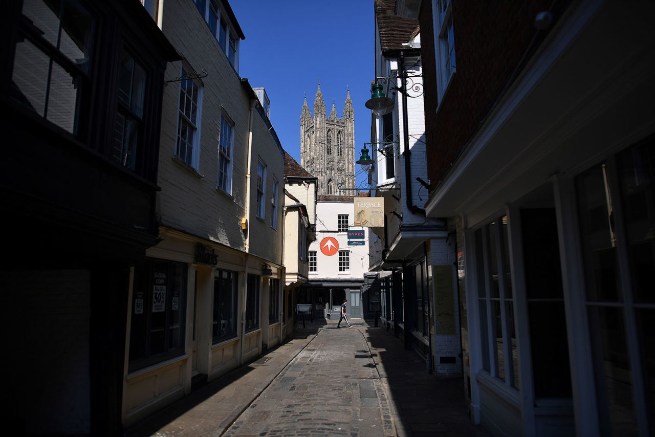 A person walks down a nearly empty street in Canterbury, England, on April 11.