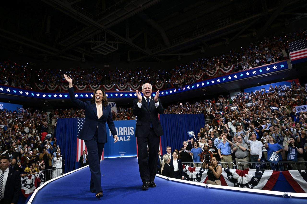 US Vice President and 2024 Democratic presidential candidate Kamala Harris, left, and her running mate Minnesota Governor Tim Walz arrive to speak at Temple University's Liacouras Center in Philadelphia, Pennsylvania, on August 6.