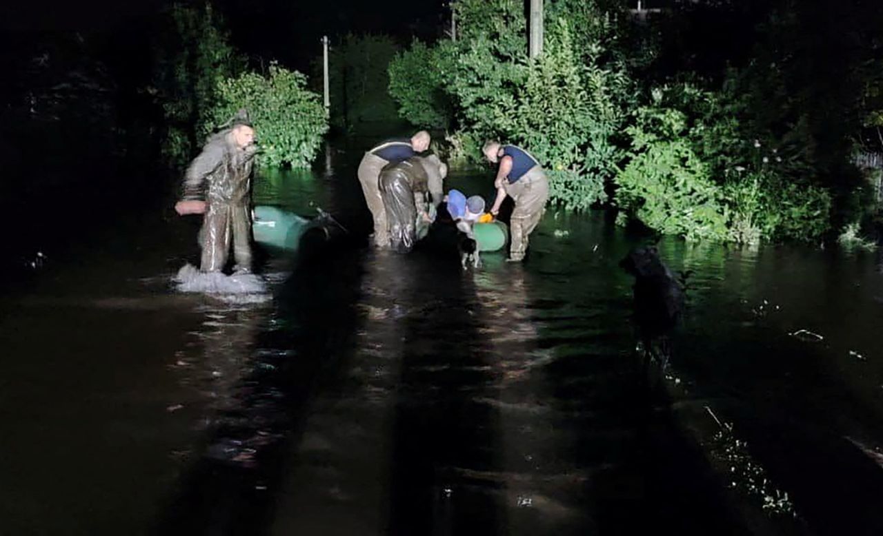 Rescuers help evacuate people from a flooded area after a Russian missile hit a hydraulic structure in Kryvyi Rih, Ukraine on September 15.