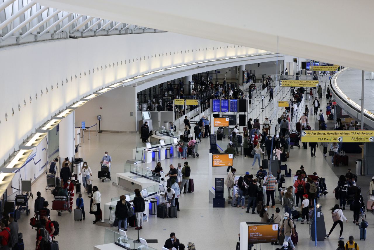 Travelers are at John F. Kennedy International Airport in Queens, New York, on March 26.