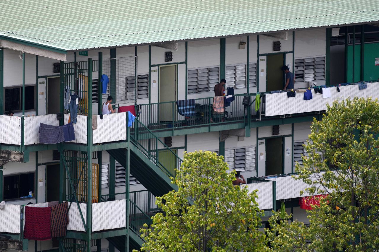 Men stand on the balcony of a dormitory used to house migrant workers in Singapore on April 17.