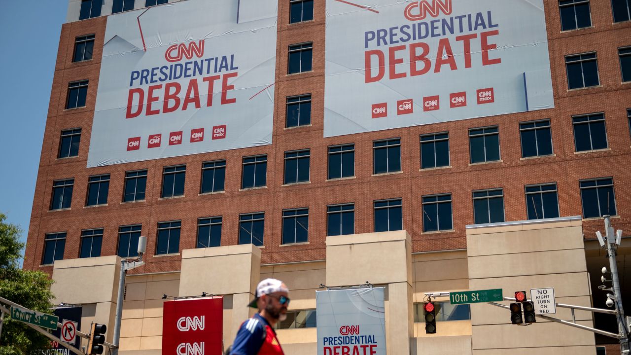 Banners hang outside of CNN’s Atlanta headquarters ahead of CNN’s Presidential Debate between President Joe Biden and former President Donald Trump on Monday, June 24.