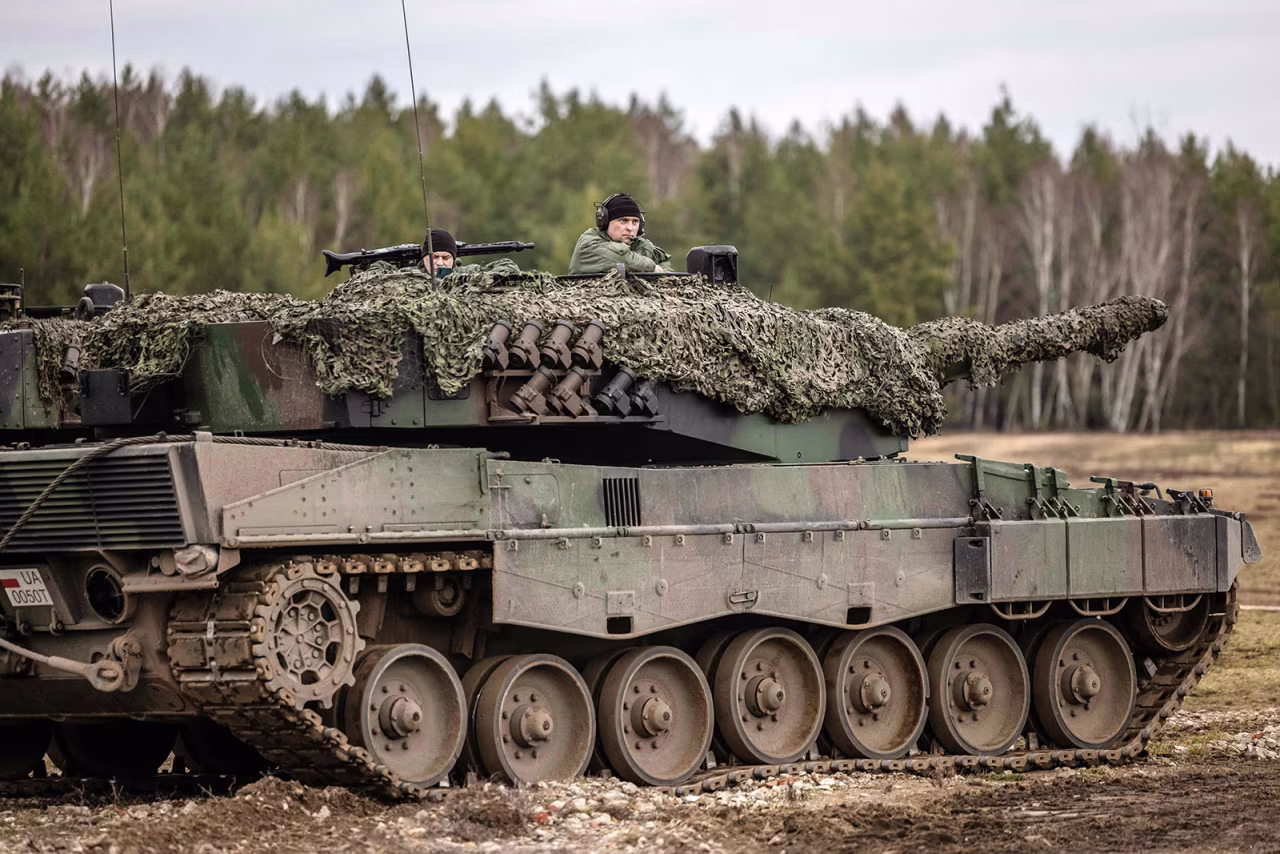 Polish and Ukrainian soldiers are seen on a Leopard 2 A4 tank during training at the Świętoszów Military Base in western Poland on Monday. 