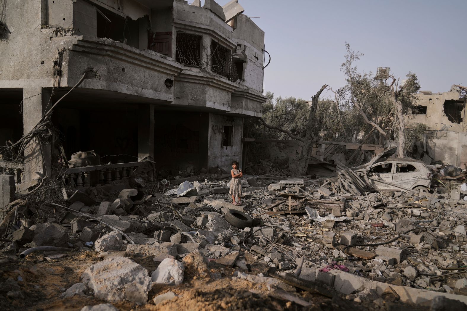 A Palestinian girl stands atop the rubble of a home that was destroyed by Israeli airstrikes in al-Zawayda, Gaza, on Tuesday, July 1.