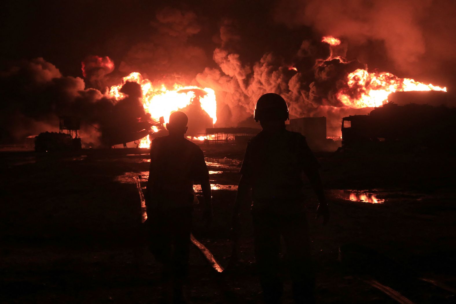 Rescuers arrive at the scene of a giant fire at an oil storage facility in Hodeidah, Yemen, on Saturday, July 20. <a href="index.php?page=&url=https%3A%2F%2Fwww.cnn.com%2F2024%2F07%2F21%2Fmiddleeast%2Fisrael-strikes-houthi-rebels-explainer-intl%2Findex.html">Israel struck Yemen for the first time</a> following a deadly drone attack launched by Houthi rebels in Tel Aviv, Israel.