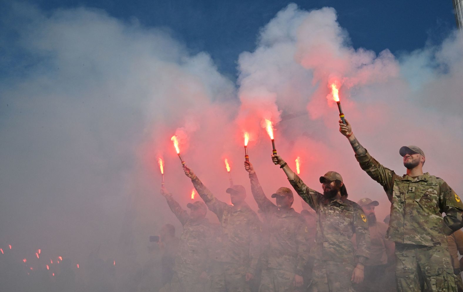 Ukrainian servicemen burn flares during a memorial event at Independence Square in Kyiv, Ukraine, on Saturday, July 29. Two years ago, <a href="index.php?page=&url=https%3A%2F%2Fwww.cnn.com%2F2023%2F07%2F25%2Feurope%2Fun-russia-ukraine-prisoners-intl%2Findex.html">more than 50 Ukrainian prisoners of war were killed in an attack</a> on the Olenivka detention center near Donetsk.