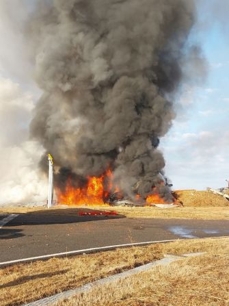 Smoke billows into the air as Jeju Air Flight 7C2216 burns, after it skid off the runway at Muan International Airport.