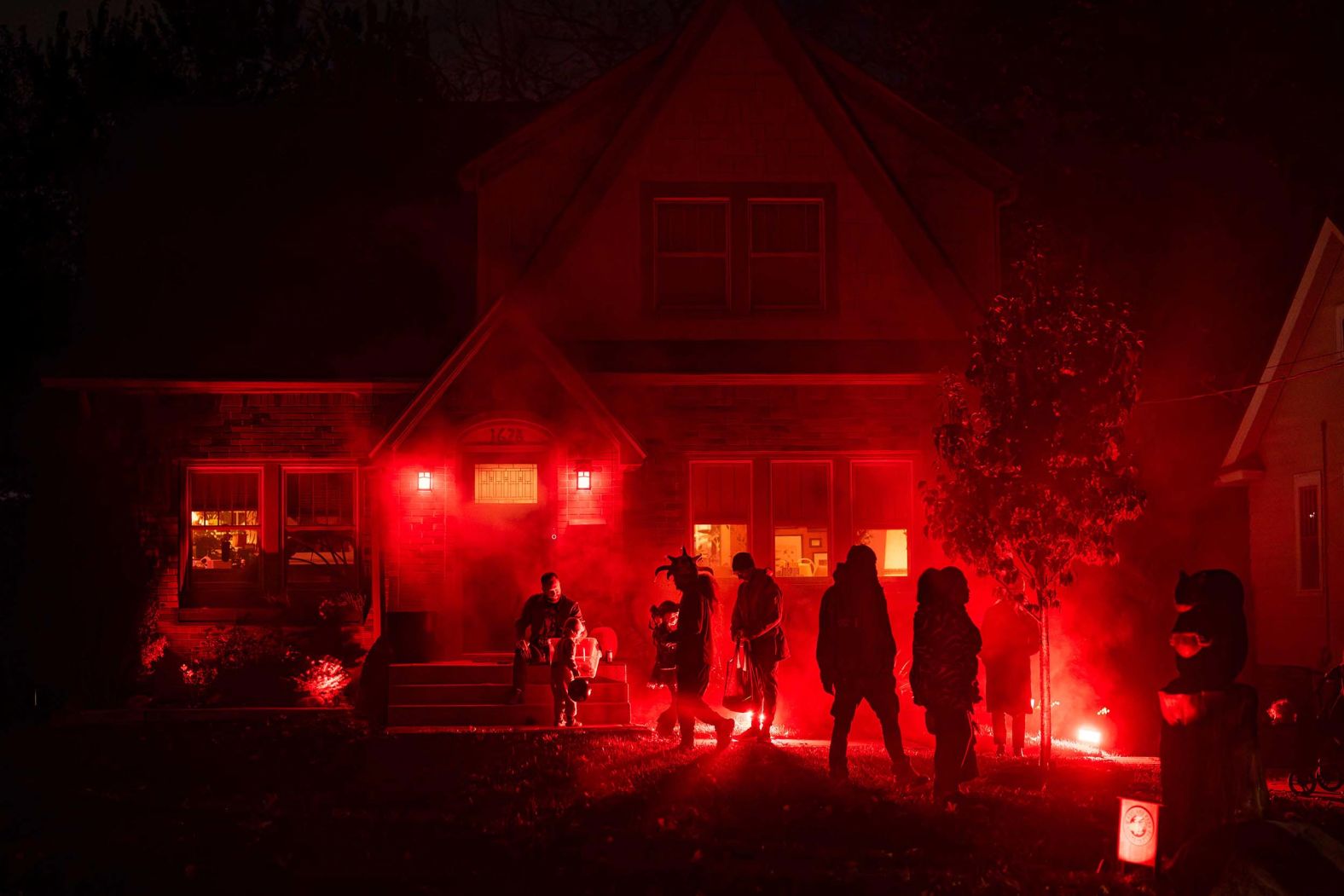 Halloween trick-or-treaters walk outside a house in Des Moines, Iowa, on Friday, October 31.