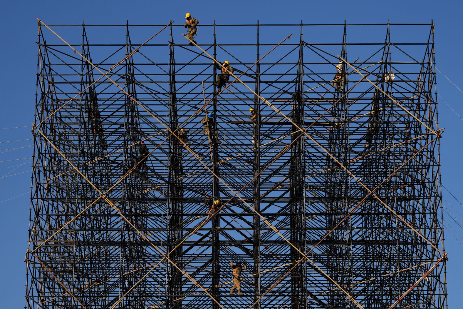 Workers prepare scaffolding ahead of a New Year’s event in Beijing on Friday, December 27.