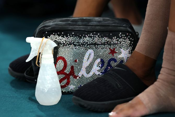 Biles’ bag is seen by her feet during the competition.