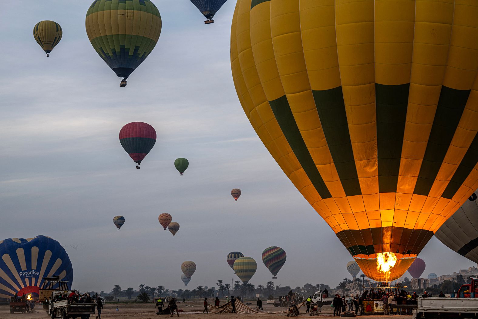 Tourists are helped into the basket of a hot-air balloon in Luxor, Egypt, on Tuesday, January 7.