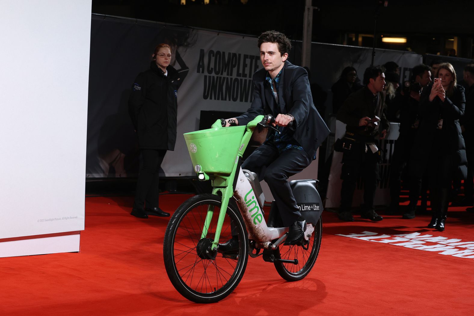 Actor Timothée Chalamet rides an electric Lime bicycle to the London premiere of his new movie “A Complete Unknown” on Tuesday, January 14. Chalamet later said <a href="index.php?page=&url=https%3A%2F%2Fwww.cnn.com%2F2025%2F01%2F16%2Fentertainment%2Ftimothee-chalamet-bike-fine%2Findex.html">he received a £65 fine</a> because he did not park the bike properly.