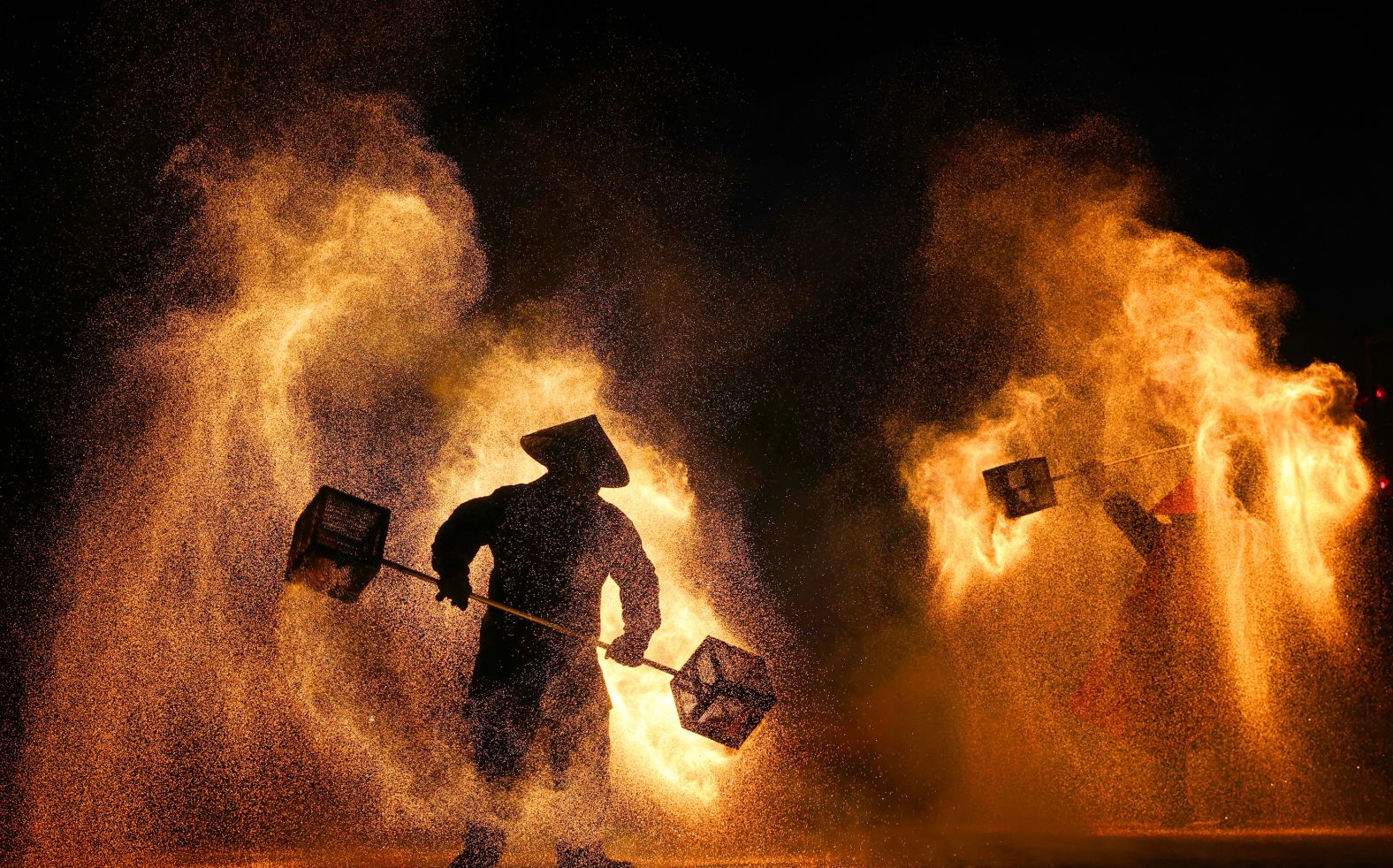 Performers create sparks with molten steel during a Lunar New Year lantern festival in Nantong, China, on Monday, January 27.