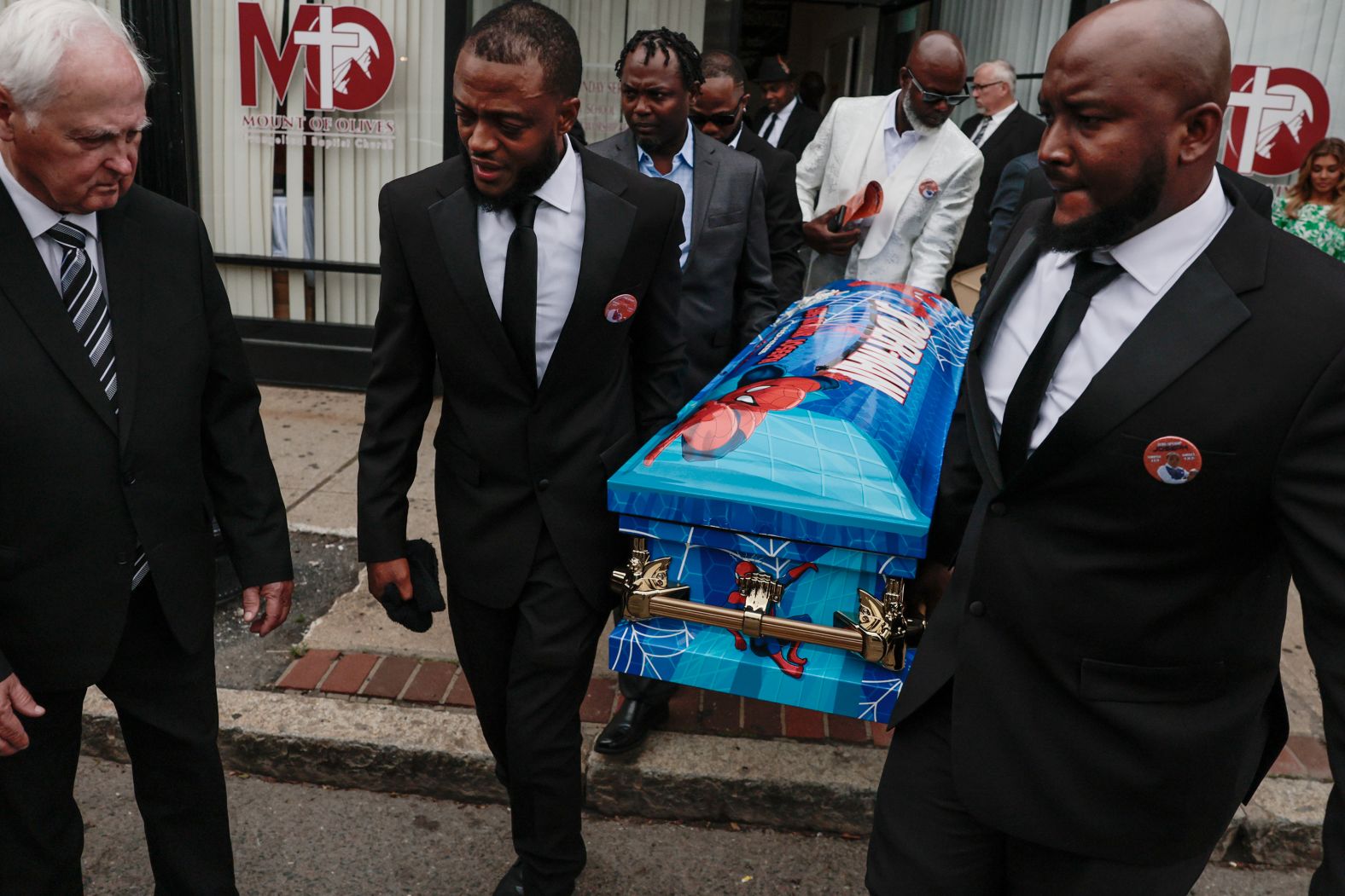 Esaie Joseph and his brother Ricardo, right, carry the casket of Esaie’s 5-year-old son, Lens, at a church in Boston on Saturday, May 17. Lens was run over by a school bus that had just dropped him off after school.