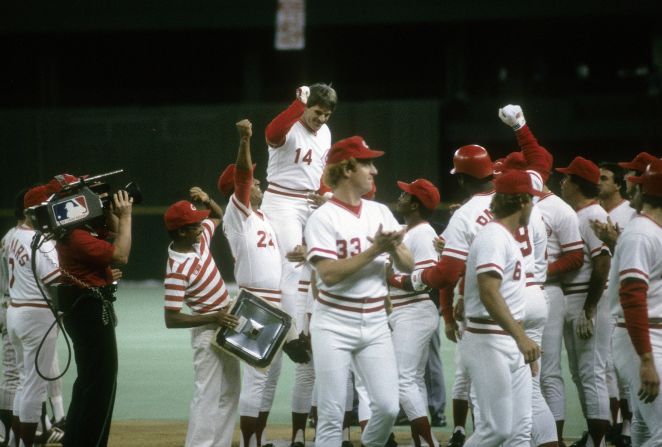 Rose — back with the Reds at the end of his career — celebrates with teammates after he broke Ty Cobb's all-time hits record in 1985.