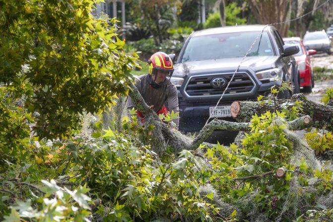 A tree crew cuts up large limbs that fell on East 49th Street in Savannah, Georgia, on September 27.