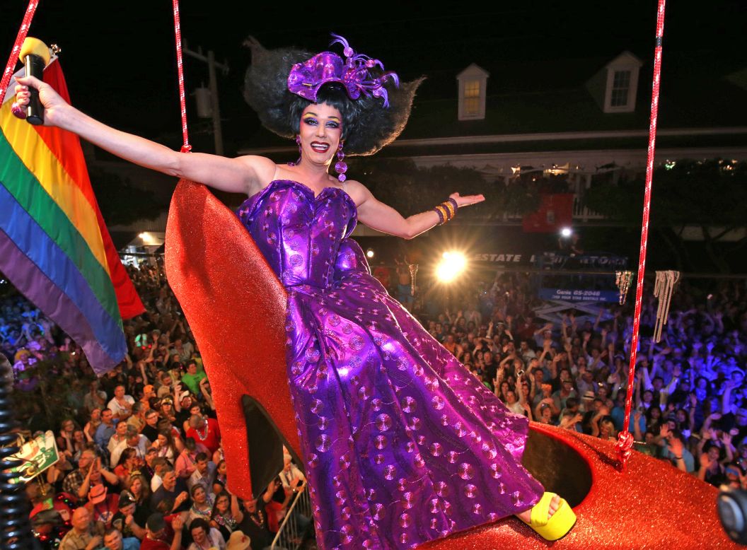 Female impersonator Gary Marion hangs in a giant replica of a woman's high heel over Duval Street in Key West, Florida.