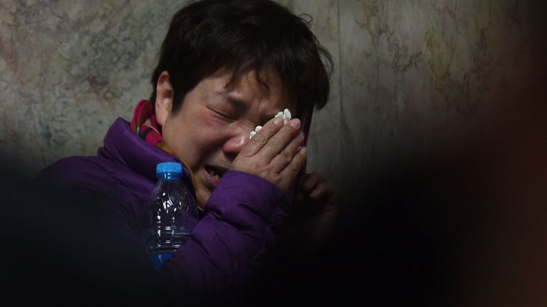 A relative of a victim of the stampede cries as she makes a phone call at a hospital in Shanghai. There were conflicting accounts of what caused the stampede.