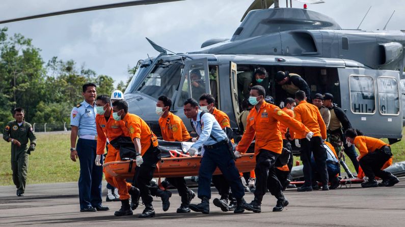 Members of a search and rescue team carry the body of a victim in Pangkalan Bun on Thursday, January 1.