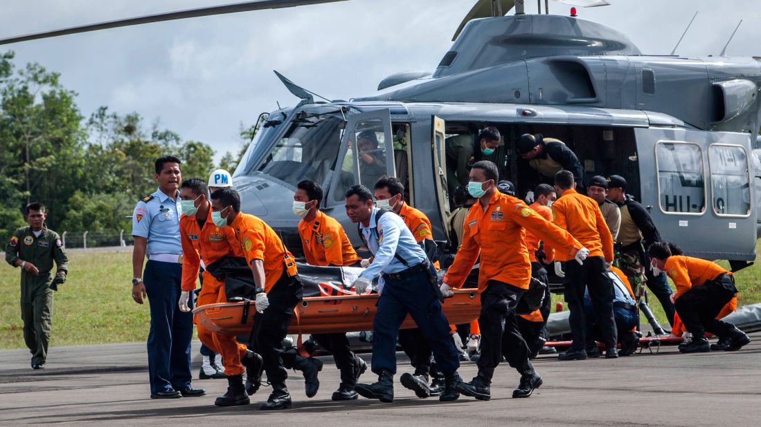 Members of a search and rescue team carry the body of a victim in Pangkalan Bun on Thursday, January 1.