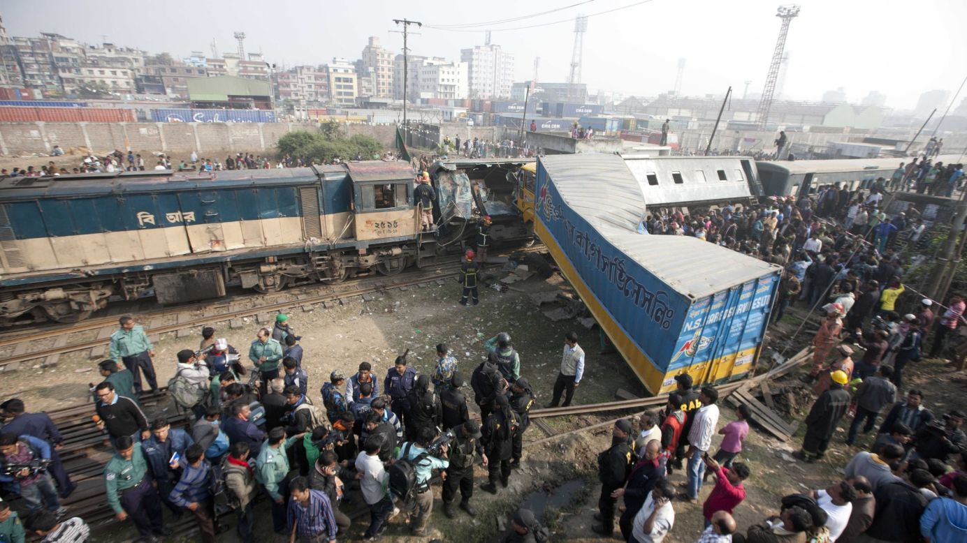 People gather in Dhaka, Bangledesh, after a truck rammed into a passenger train Monday, December 29. Several people were killed and more than 20 were injured.
