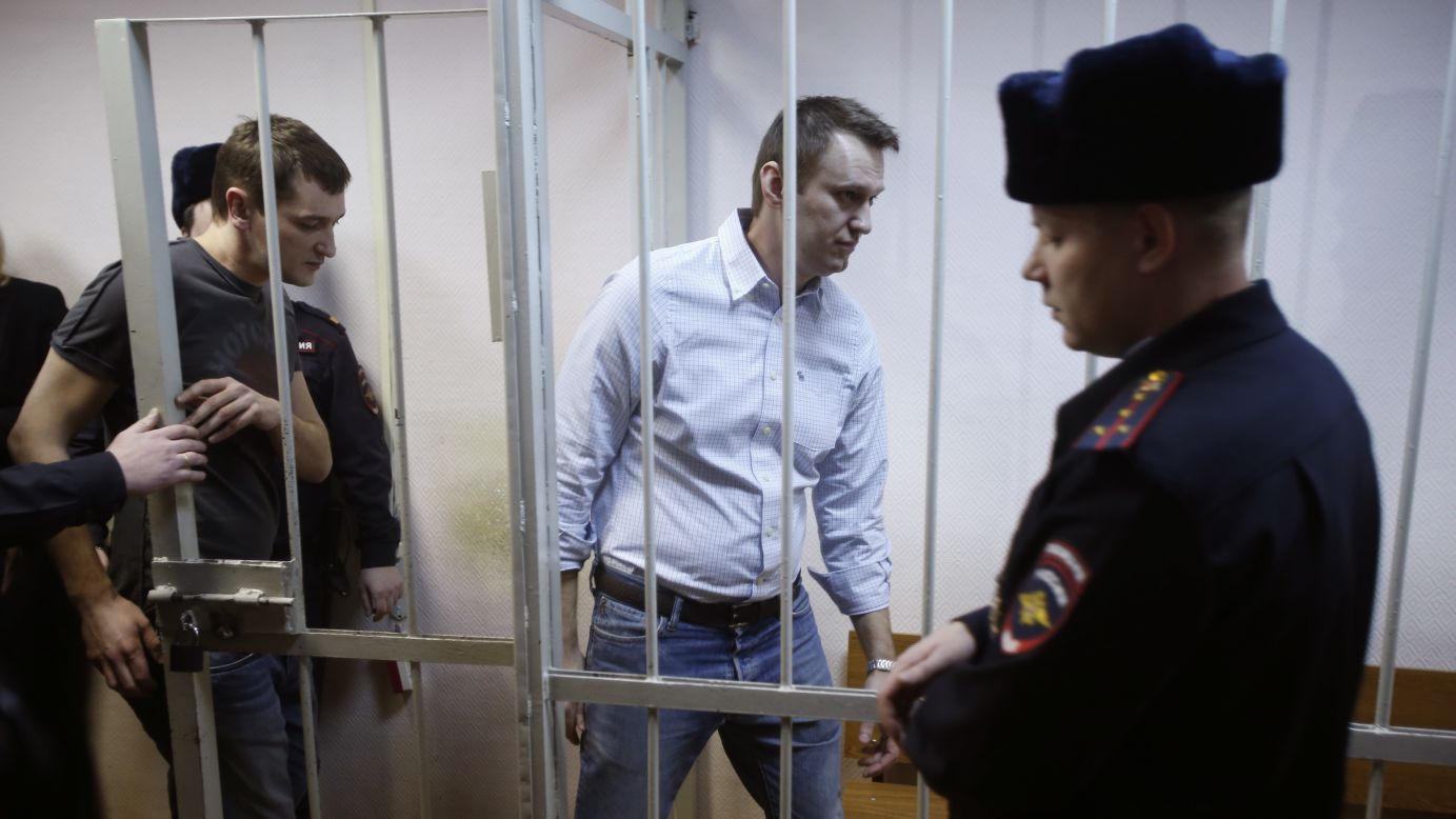 Blogger and Kremlin critic Alexey Navalny, second from right, enters a cage at a court in Moscow on Tuesday, December 30. He and his brother Oleg, left, <a href="http://www.cnn.com/2014/12/30/world/europe/russia-alexei-navalny-case/index.html" target="_blank">were convicted of fraud</a> and given a suspended sentence of three and a half years. The brothers denied charges of embezzling 30 million rubles ($540,000) from a Russian subsidiary of French cosmetics company Yves Rocher between 2008 and 2012.